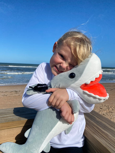 Child holding Ocearch Shark Plushie