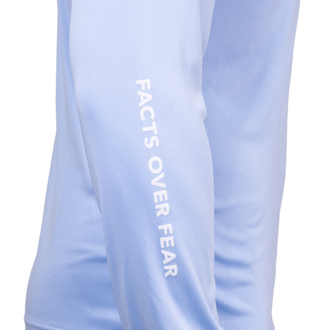 Closeup of sleeve of blue mist Performance Hoodie showing white "FACTS OVER FEAR" text