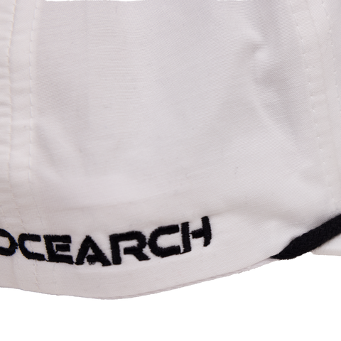 closeup of side of white 5-Panel Unstructured Flatbill Snapback with "OCEARCH" text