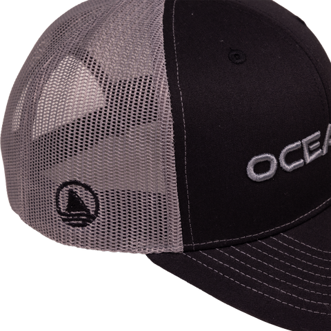 closeup of side of black/charcoal snapback showing icon Ocearch logo