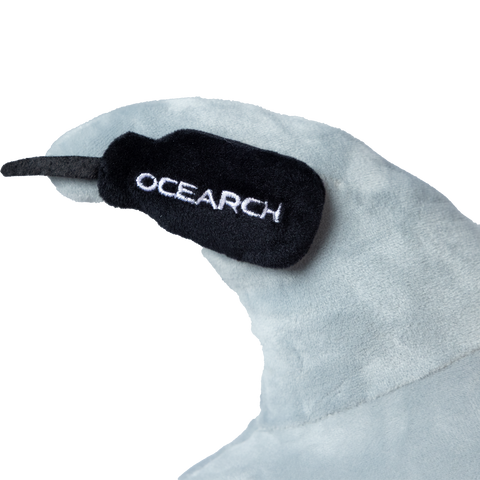 Close-up of a shark fin on plushie with 'OCEARCH' tracker