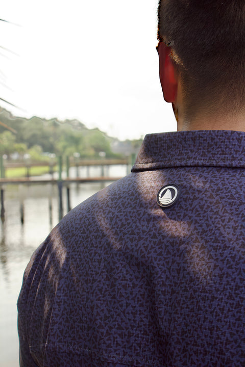 closeup of ocearch logo on back of paradise dark blue pattern buttondown
