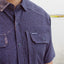 closeup of ocearch label on chest pocket of paradise dark blue pattern buttondown