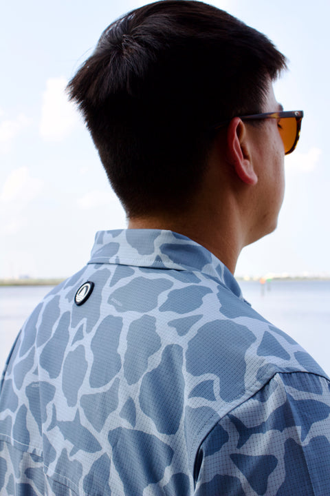 rear view of man in light blue Ocearch camo shirt