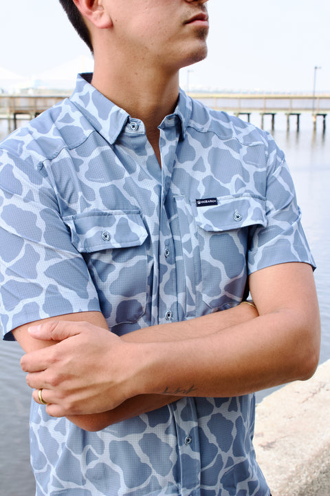 man wearing light blue Ocearch camo shirt