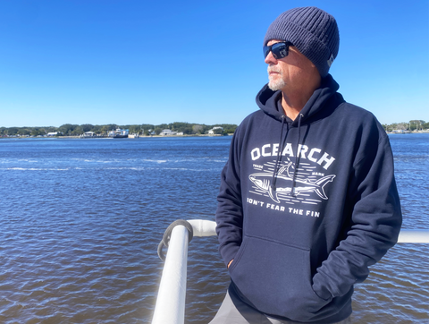 man overlooking water wearing tracker hoodie